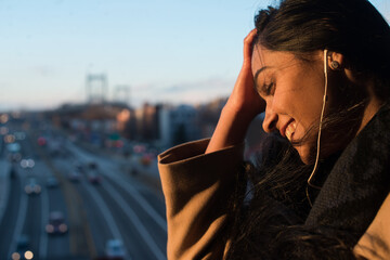 Happy young woman listening to music