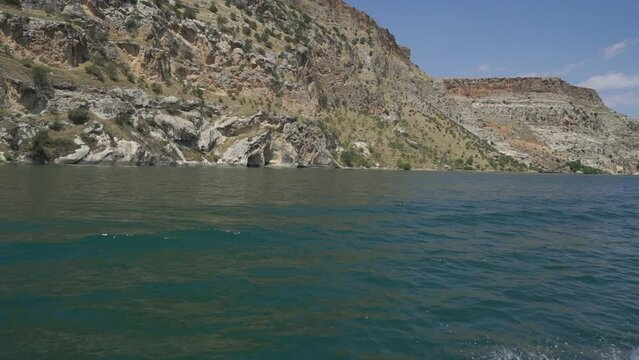 View of sailing ferry boat on azure river on Euphrates River in Halfeti, Sanliurfa, Turkey.