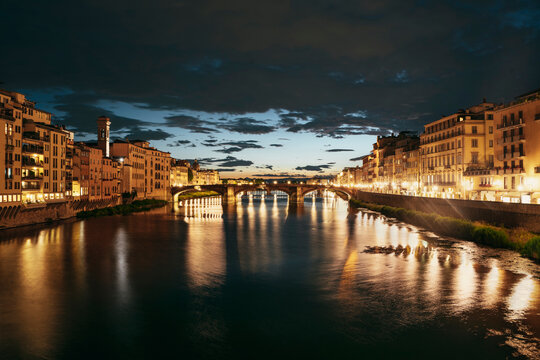 Ponte Santa Trinita and the River Arno at night.
