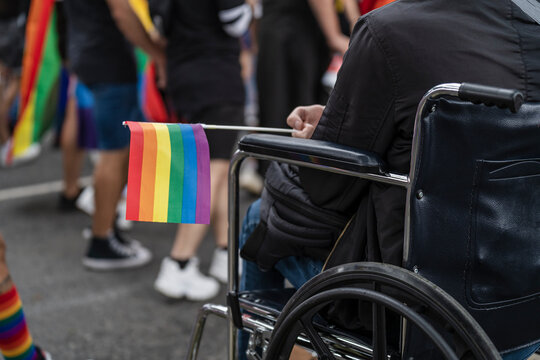 person in a wheelchair at a lgbt march