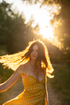 Blurry image of woman dancing in the forest