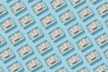 Dollars in disposable boxes pattern on blue.
