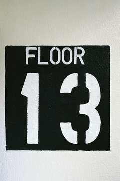 Stenciled sign for Floor 13