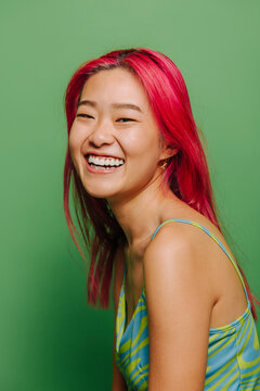 Cheerful Asian woman with closed eyes