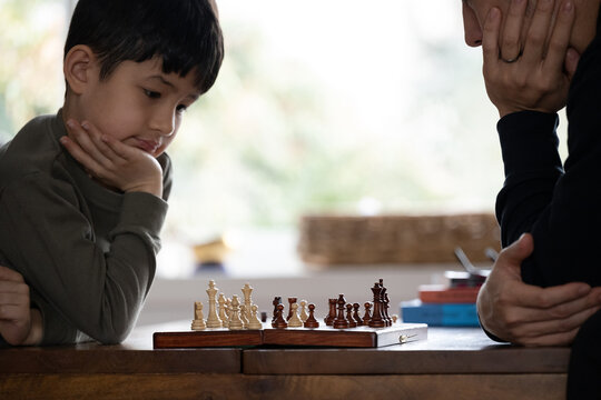 Premium Photo  Two young man are playing chess