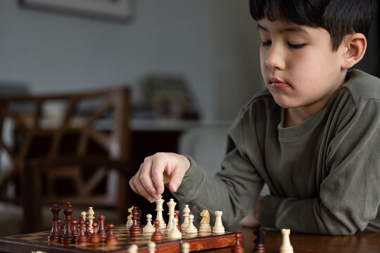 Little kid playing chess