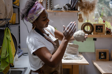 Shaping a chunk of clay to basic form for pottery