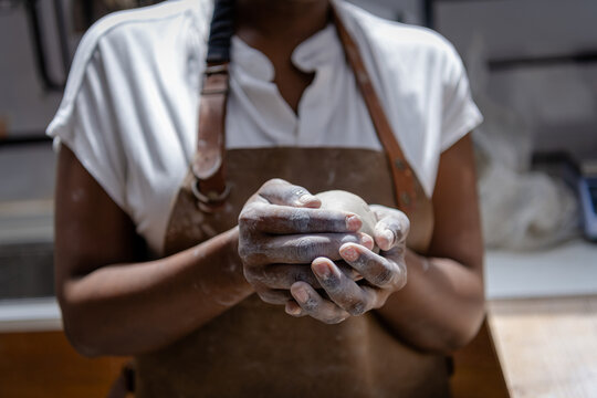 Shaping a chunk of clay to basic form for pottery