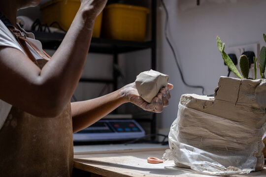 Shaping a chunk of clay to basic form for pottery