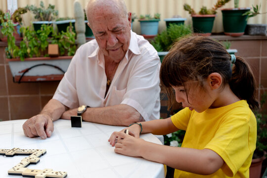 Family time playing domino with grandfather