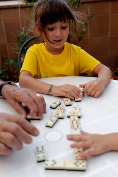 Family time playing domino with grandfather
