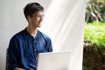 Young man using laptop computer outdoor