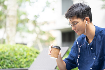 Young man enjoying coffee outdoor.