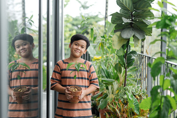 Child holding a pot in the foreground.