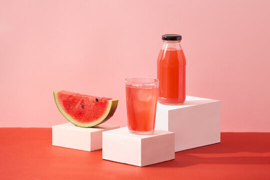 A glass of watermelon juice surrounded with a slice red