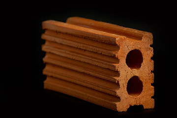 Solid clay bricks used in construction are laid on a black background.