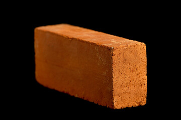Solid clay bricks used in construction are laid on a black background.