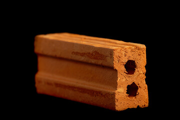 Solid clay bricks used in construction are laid on a black background.
