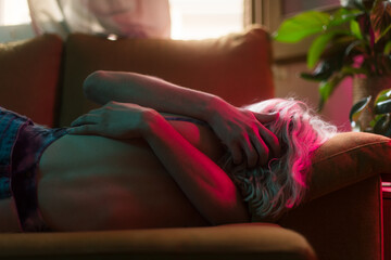 Anonymous affectionate couple hugging on sofa