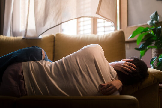 Anonymous affectionate couple lying on the sofa