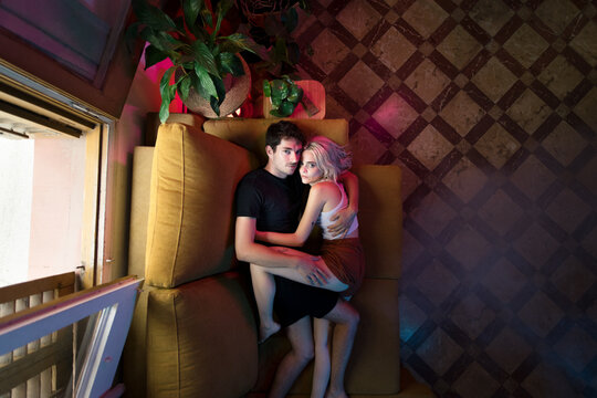 Portrait of lovers on the sofa looking at camera