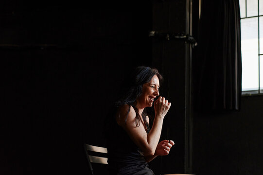 Mature actress laughing while acting