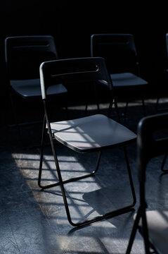 Chairs in a dark modern dance studio