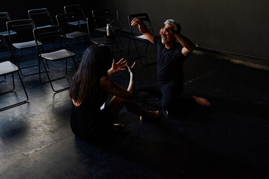 Modern dancers rehearsing on a studio floor