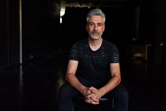 Mature male dancer sitting in a studio