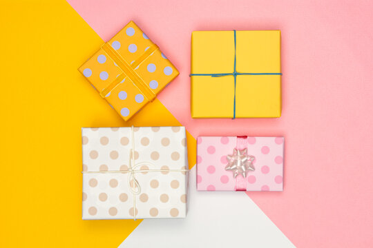 Pastel presents scatted over pink background