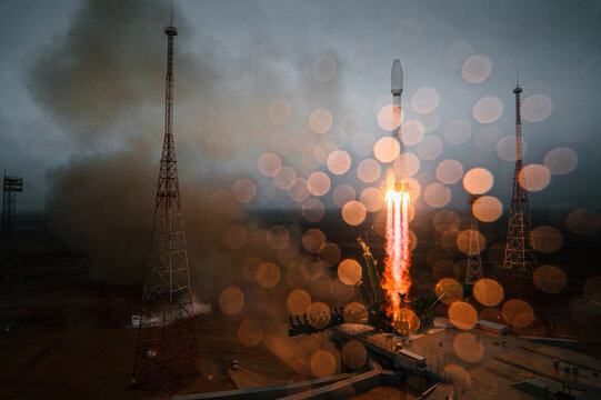 space rocket lift-off, bright flame through the rain drops