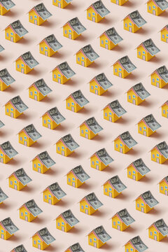 Paper houses with dollar banknote roof pattern.