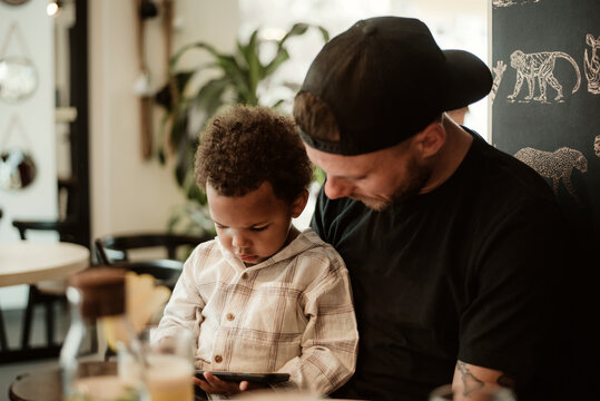 Toddler watching at the phone 