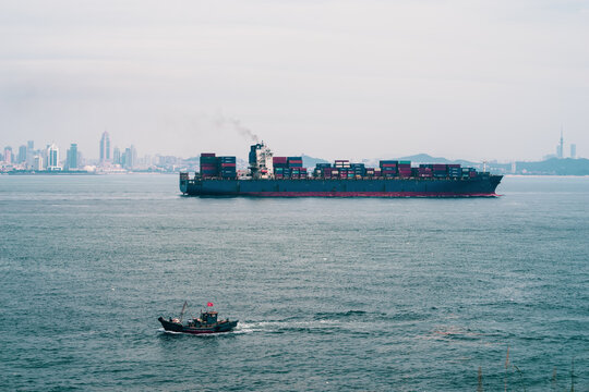 A large container ship and a small fishing boat