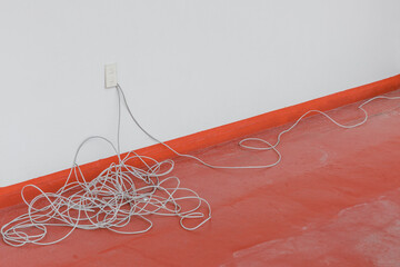 Close-up of internet cables tangled on the floor.