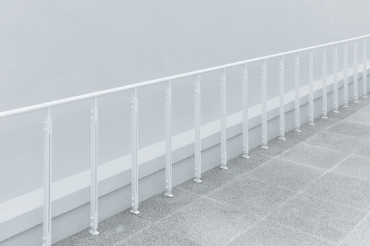 Close-up of a white railing installed in a passageway.