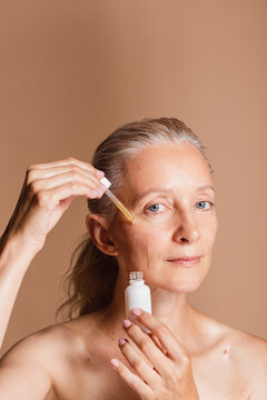 Woman Taking Serum With A Dropper