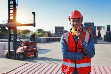 Foreman engineer using walkie talkie radio control loading containers box. Confident engineering with helmet work at container cargo site and checking industrial container cargo freight ship