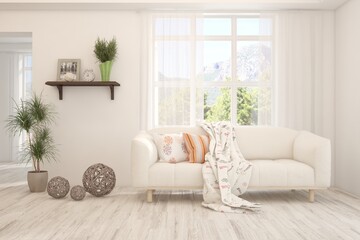 Fototapeta premium White living room with sofa and summer landscape in window. Scandinavian interior design. 3D illustration