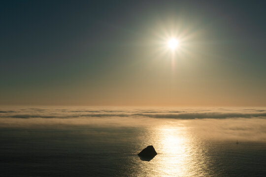 Sailboat sailing at sunset along Finisterre Cape, Atlantic Ocean 
