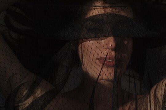 Closeup portrait with eyes covered with black veil