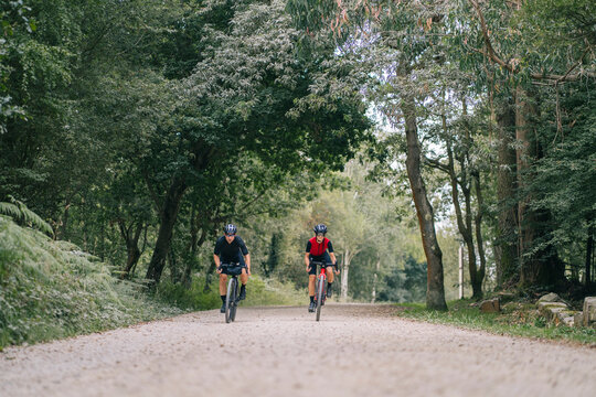 Cyclists riding on road in countryside