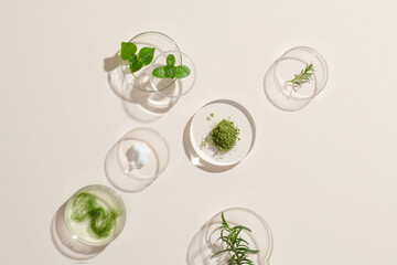 Cream and natural ingredients on white table in cosmetic laboratory