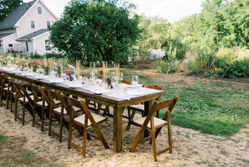 View of a long event table with decor and flower arrangements 