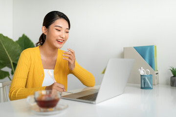 Young woman with laptop at home