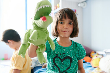 Girl playing with a toy dinosaur