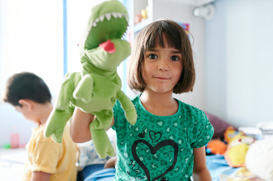 Girl playing with a toy dinosaur