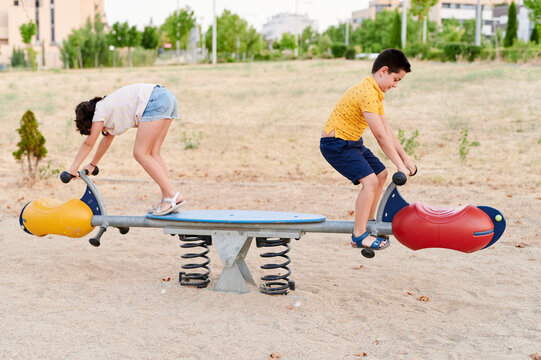 Children playing on a park seesaw