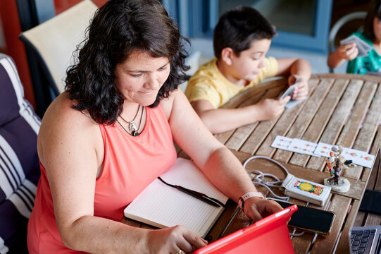 Mom working from home next to her kids outdoors