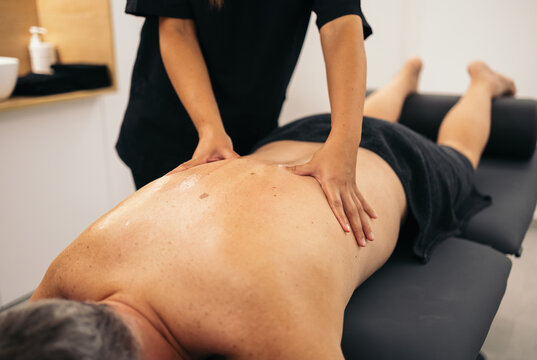 Therapist massaging a patient in a physiotherapy clinic